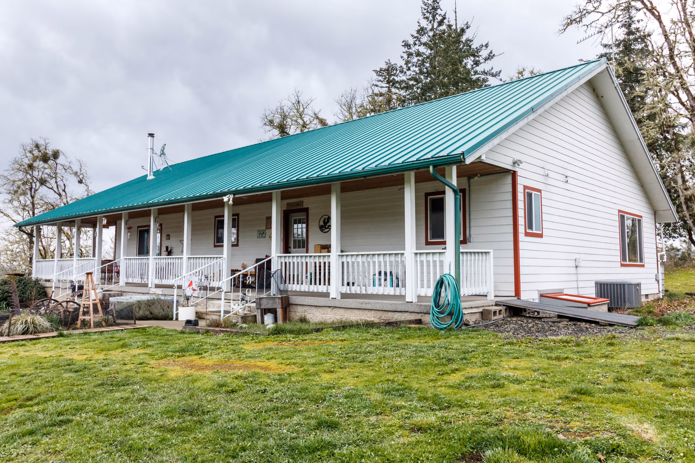 Douglas County rural ranch house with green metal roof — strategic improvement program by Aaron Cherry